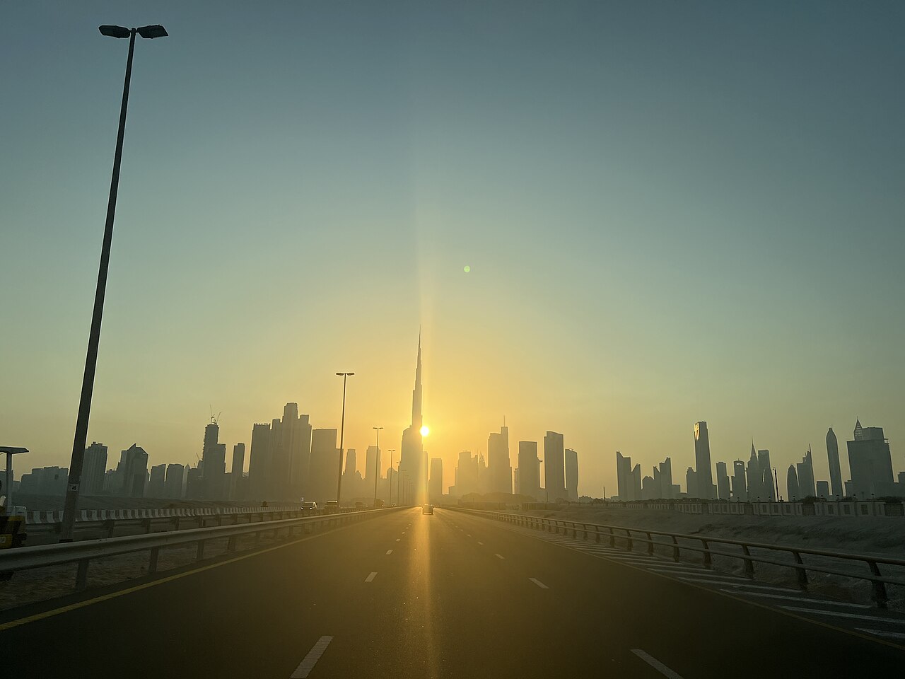 Burj Khalifa tower and Dubai UAE skyline at sunset